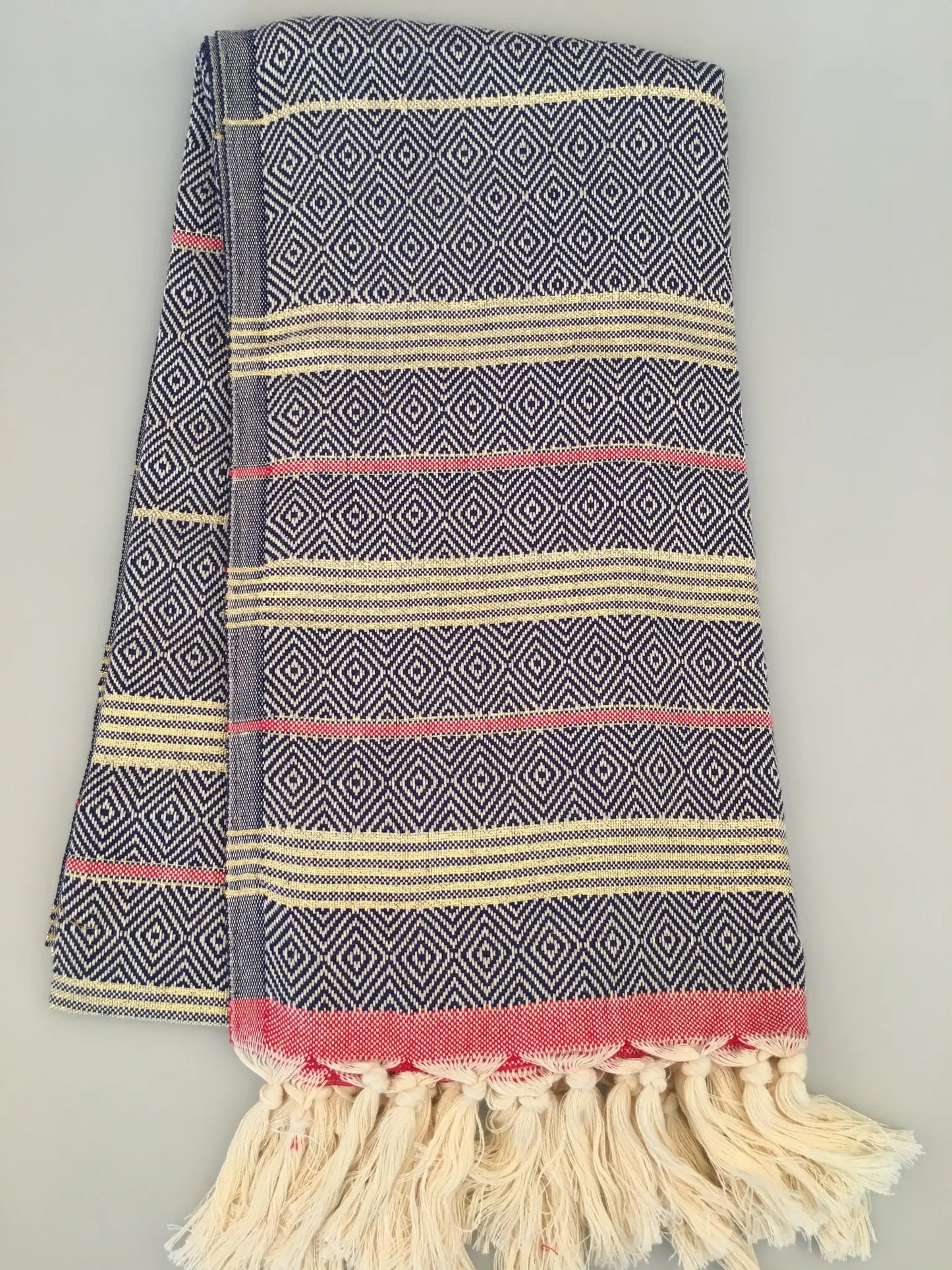 "Lycia Xanthos Turkish towel peshtemal in blue and white diamond pattern with red and cream stripes, fringed edges."
