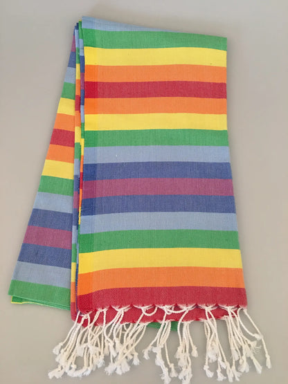 Colorful Cadyanda Turkish towel peshtemal with horizontal stripes in red, yellow, green, blue, and white fringes.