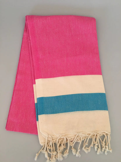 "Blaundos Turkish towel peshtemal in bright pink with cream and teal stripes, displayed flat with fringed edges."